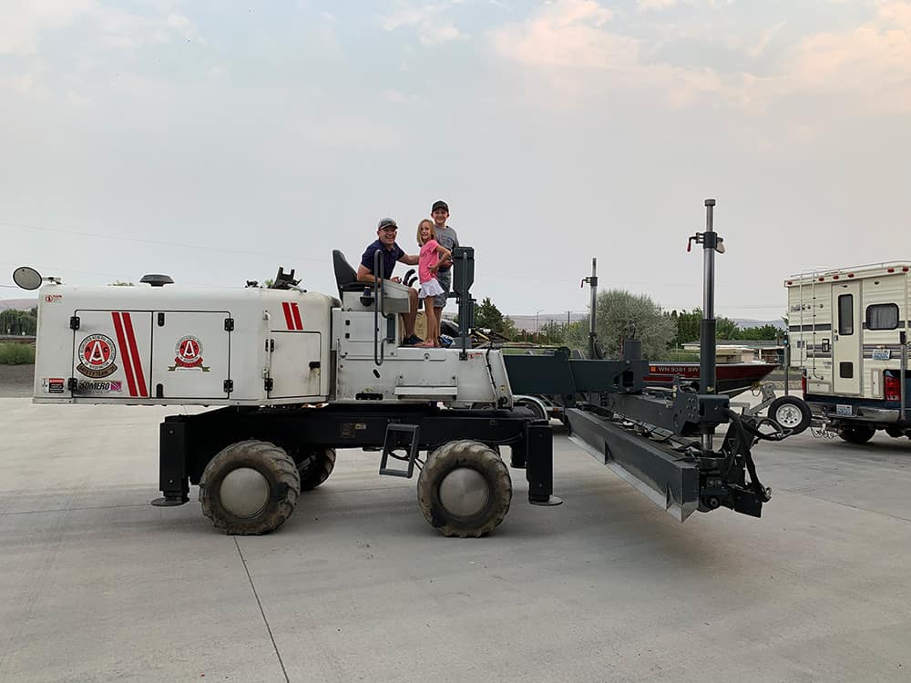 Matt Poppoff and family sitting on Laser Screed