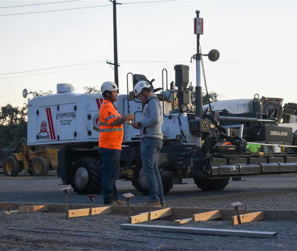 Two Poppoff workers in front of laser screed