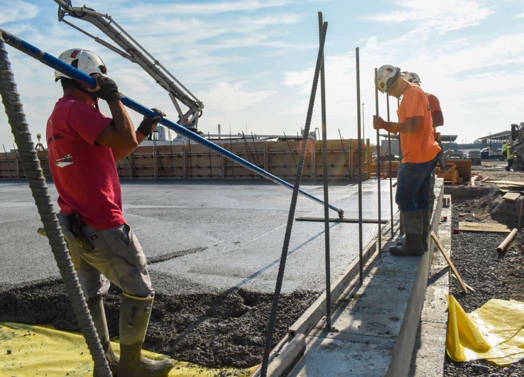 Poppoff employees smoothing concrete