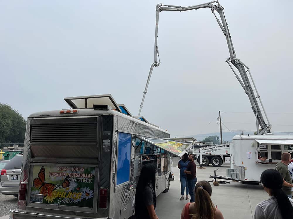 Food truck at company picnic with concrete pump in background