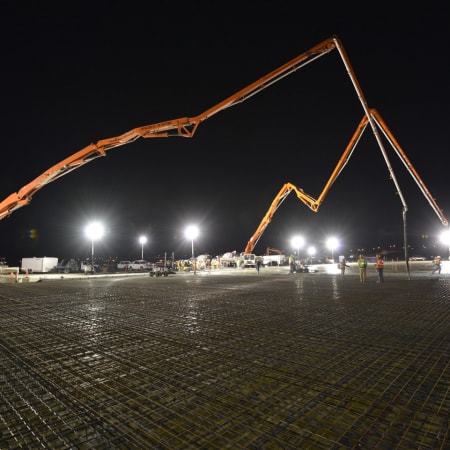 Concrete pumps placing concrete slab
