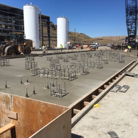 Concrete slab with embedded anchor bolts