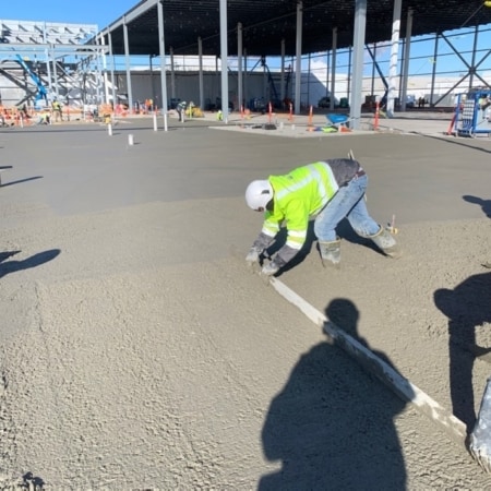 Concrete contractors smoothing concrete slab