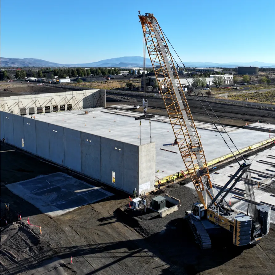 Tilt-up construction crane lifting concrete wall panels