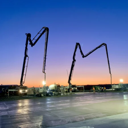 Two concrete pumps at sunrise